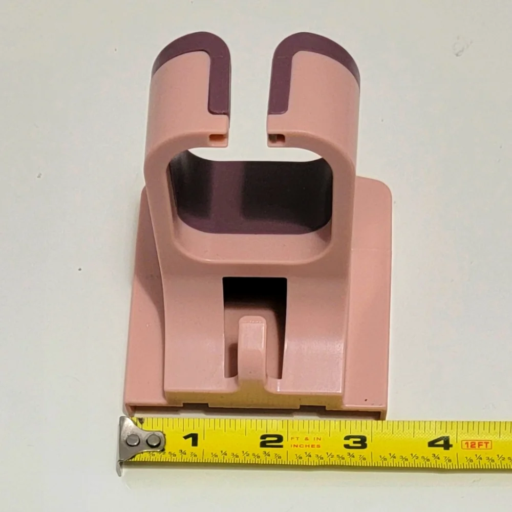 Pink and Purple Wall-Mounted Blow Dryer Holder.